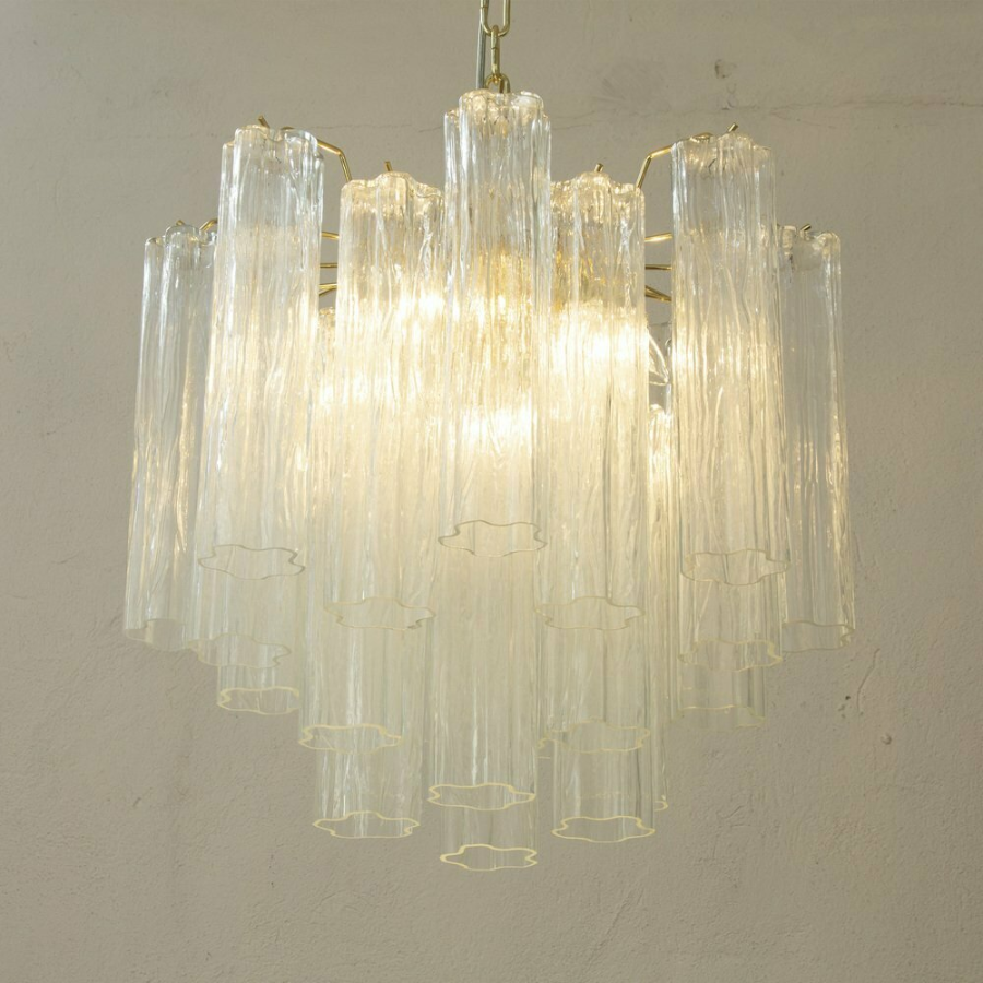 Chandelier with glass shades on a plain wall